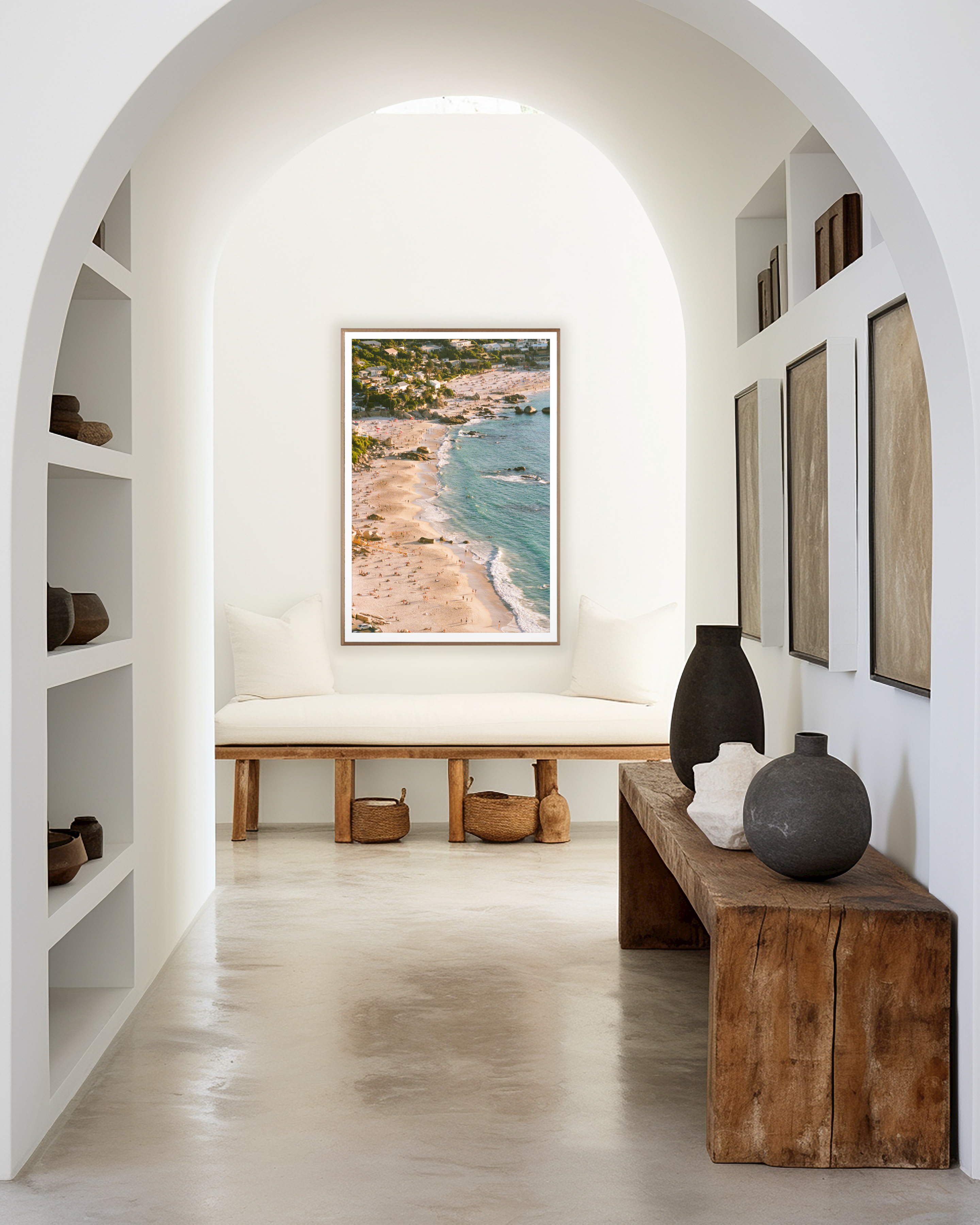 Narrow hallway with wooden benches, decorative vases, and a beach-themed wall art.
