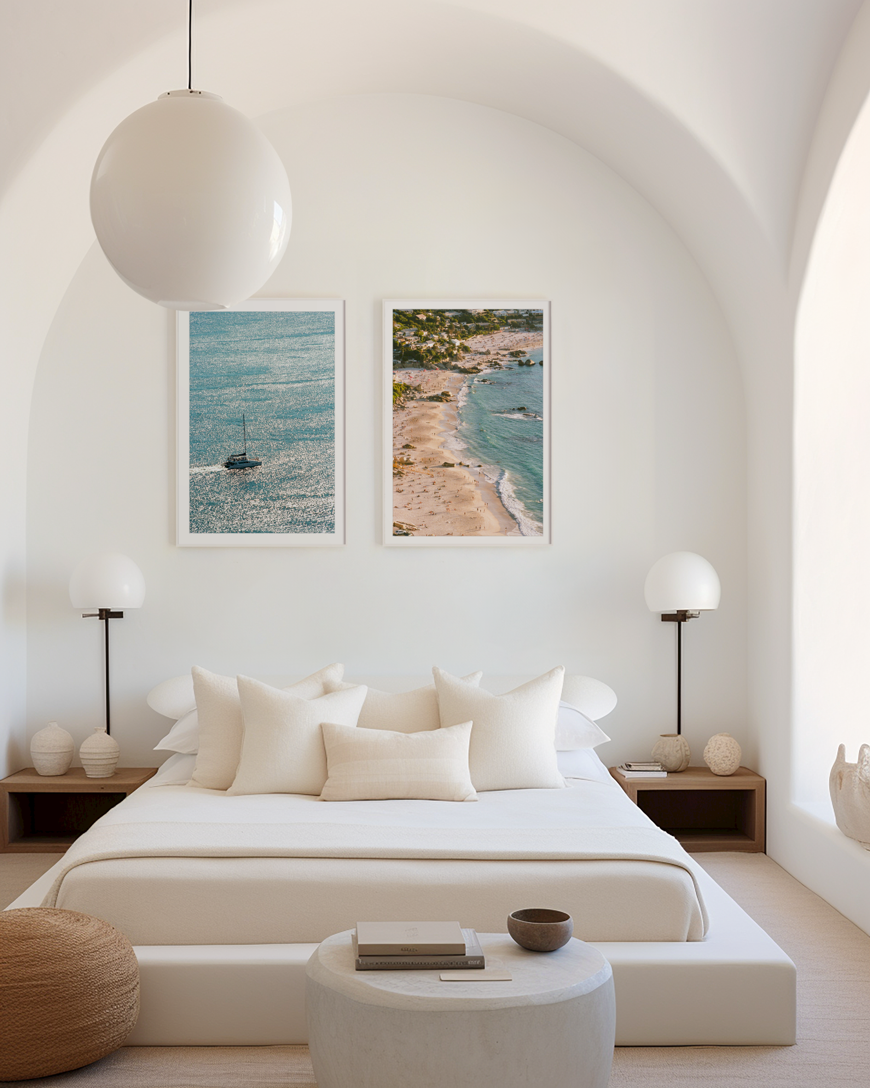 Modern bedroom with white bed, nightstands, and wall art of a beach.