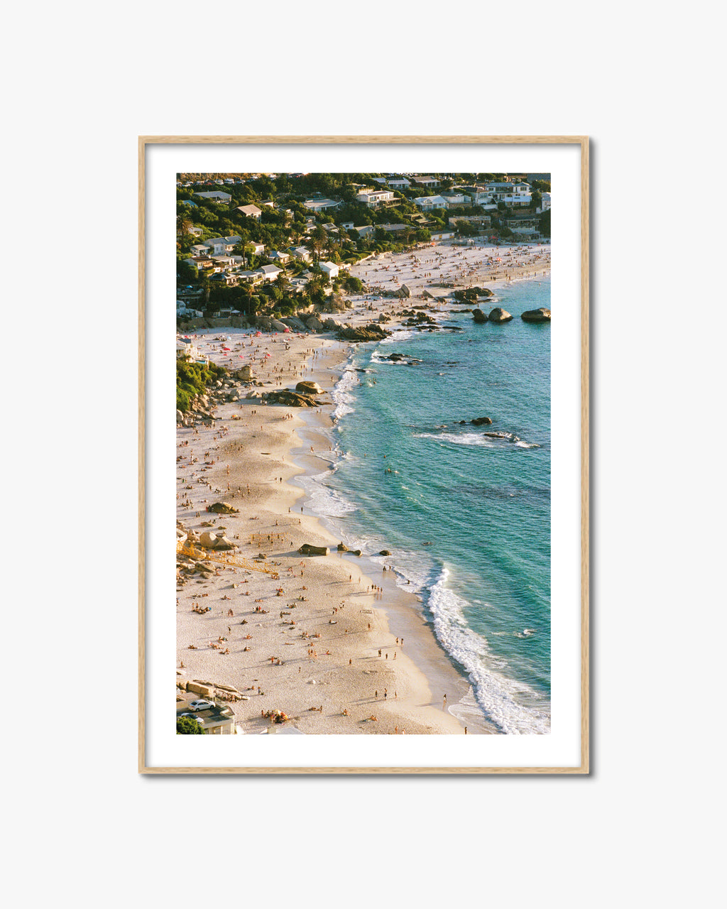 Framed artwork of a beach scene in Cape Town with turquoise water and sandy shore in an oak frame.