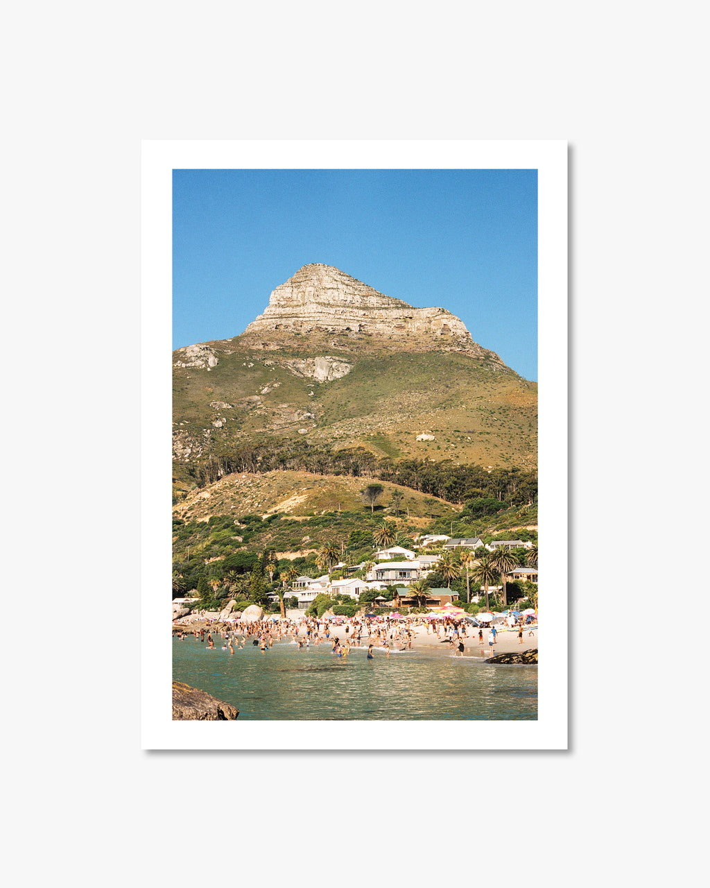 Framed photograph of a coastal scene with a mountain and beach.