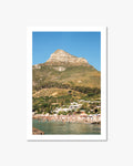 Framed photograph of a coastal scene with a mountain and beach.