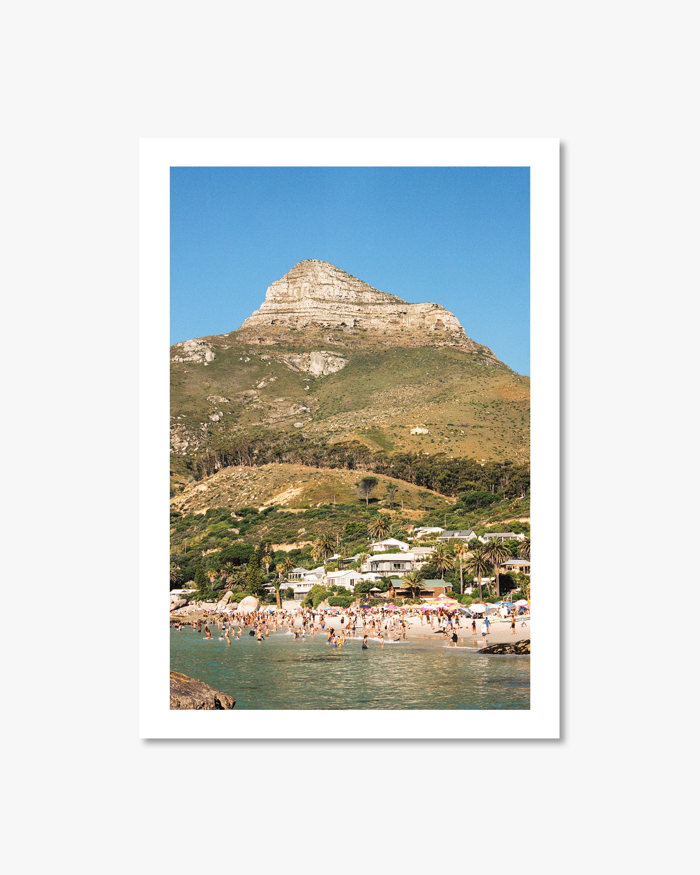 Framed photograph of a coastal scene with a mountain and beach.