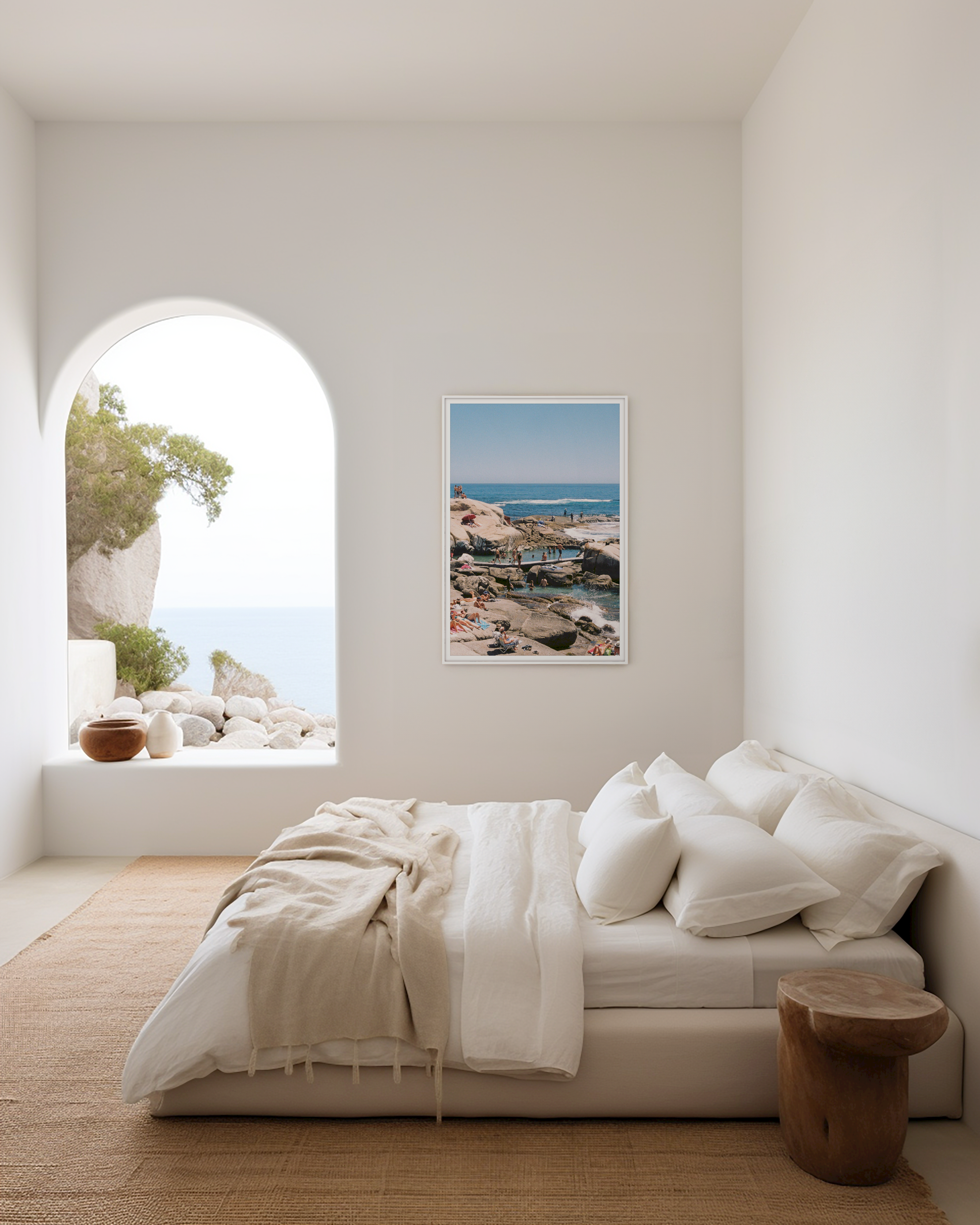 Modern bedroom with a large window, bed, and wall art of a coastal scene.