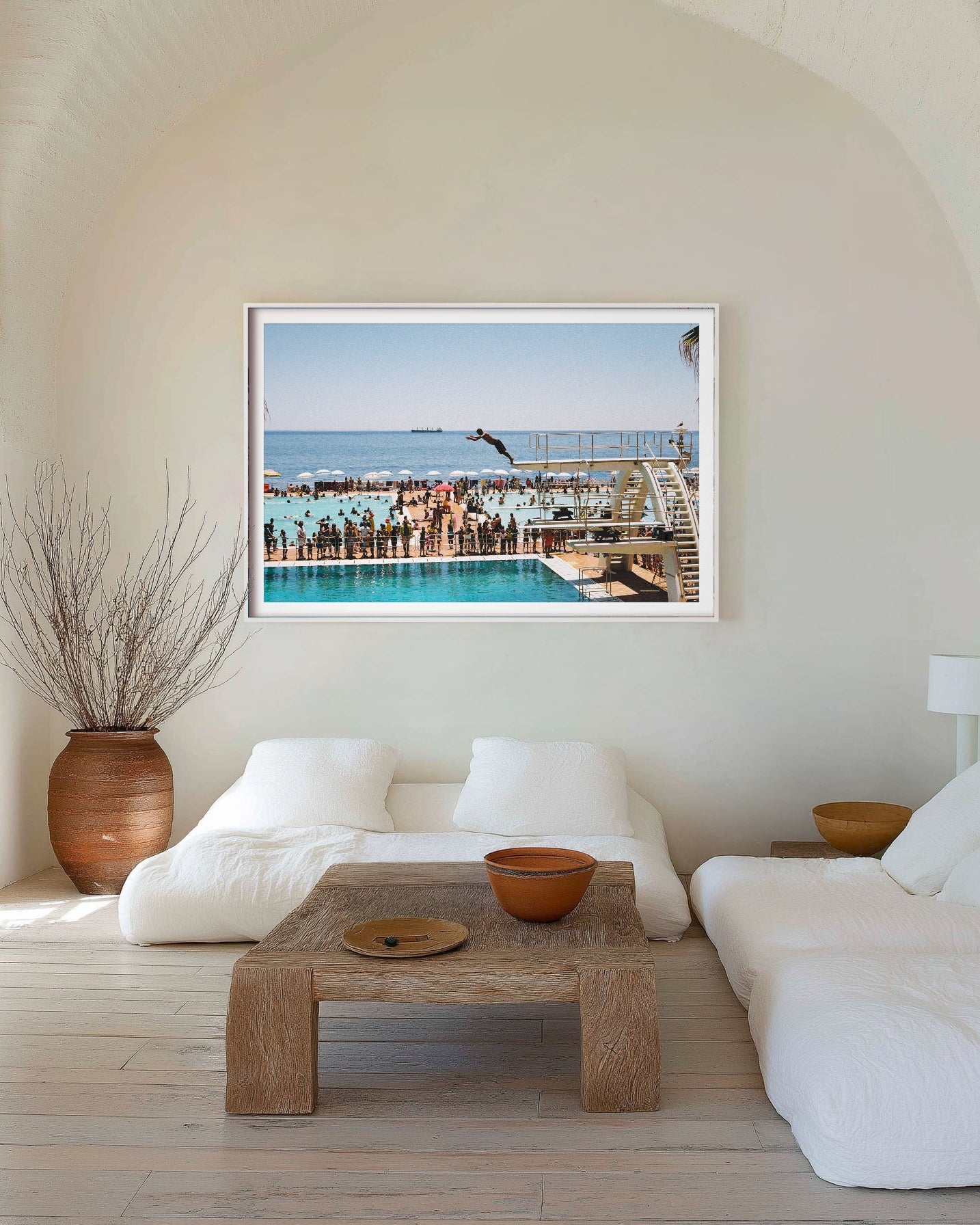 Modern living room with a large framed picture of a pool scene on the wall.