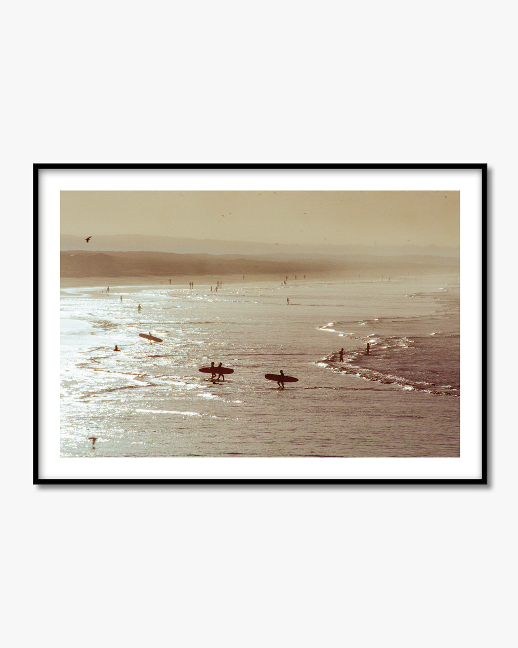 Framed artwork of a beach scene with people on surfboards and a horizon line.