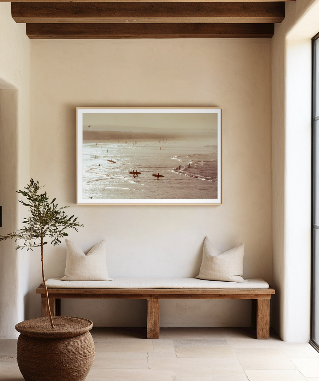Nautical-themed wall art above a wooden bench with cushions in a minimalistic room.