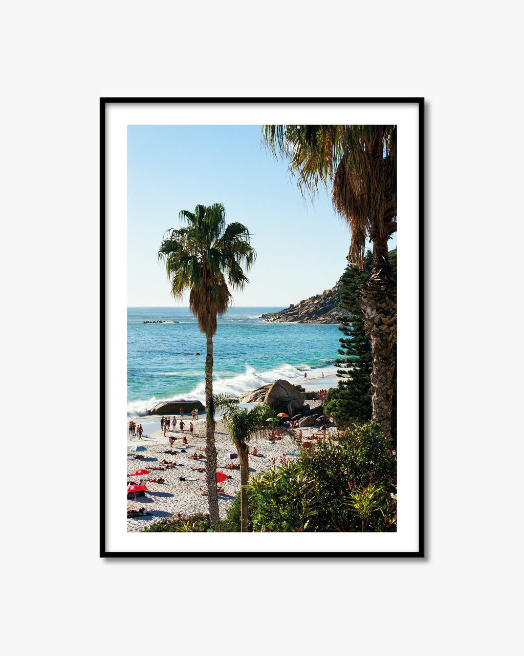 Framed artwork of a beach scene with palm trees and turquoise water.