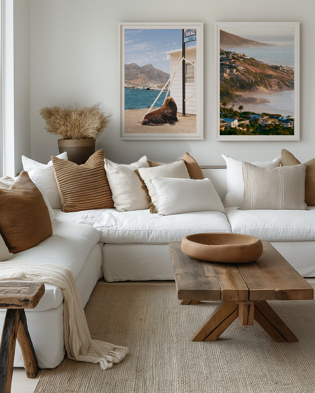 Cozy living room with a white sofa, wooden coffee table, and scenic wall art.