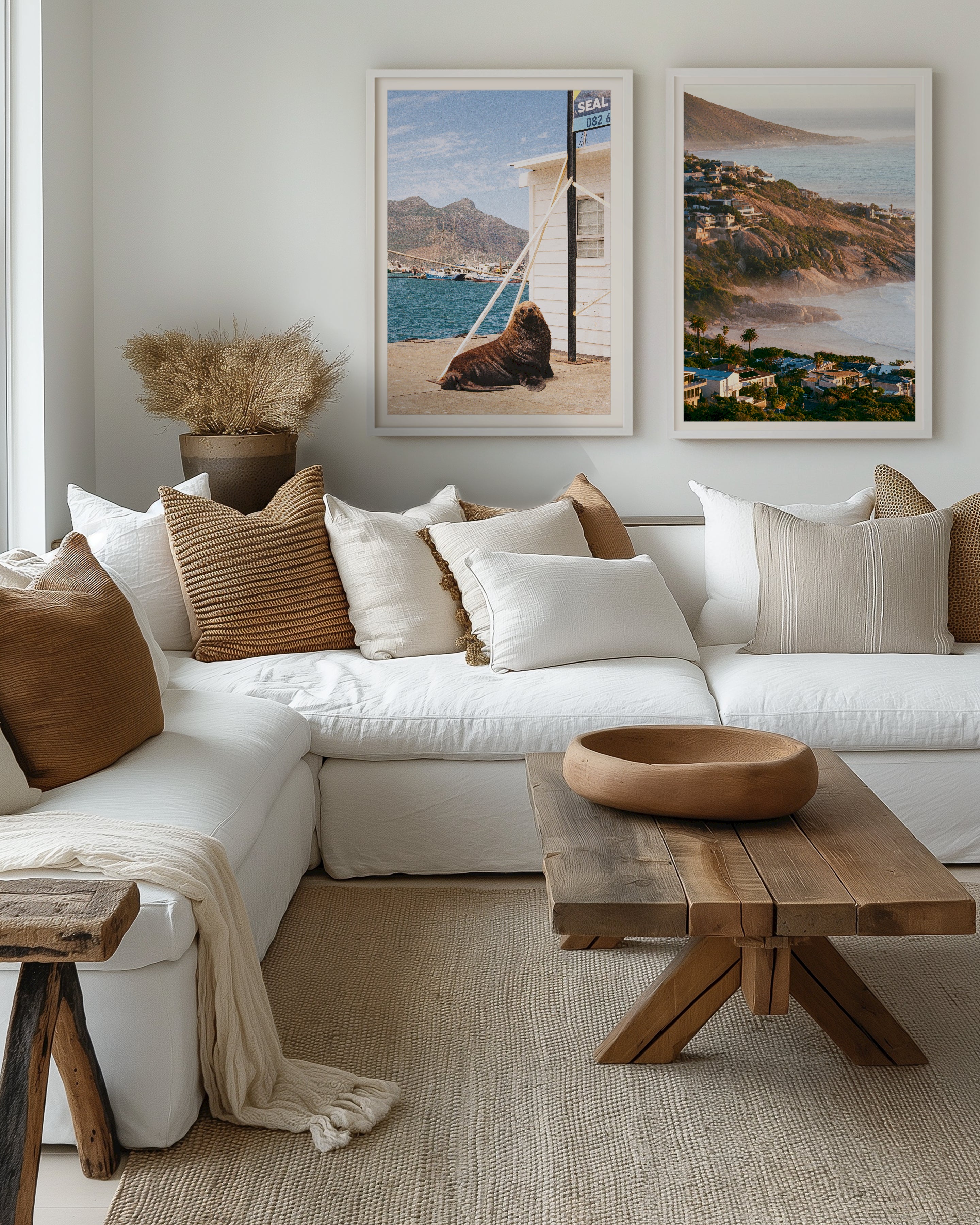 Cozy living room with a white sofa, wooden coffee table, and scenic wall art.